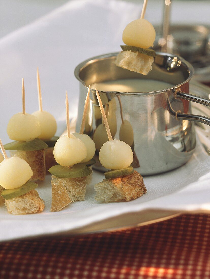 Bread kebabs with mixed pickles by & above cheese fondue pot