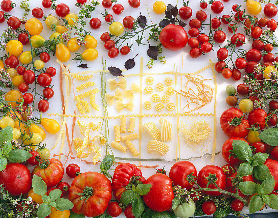 Different kinds of pasta with colorful tomato varieties