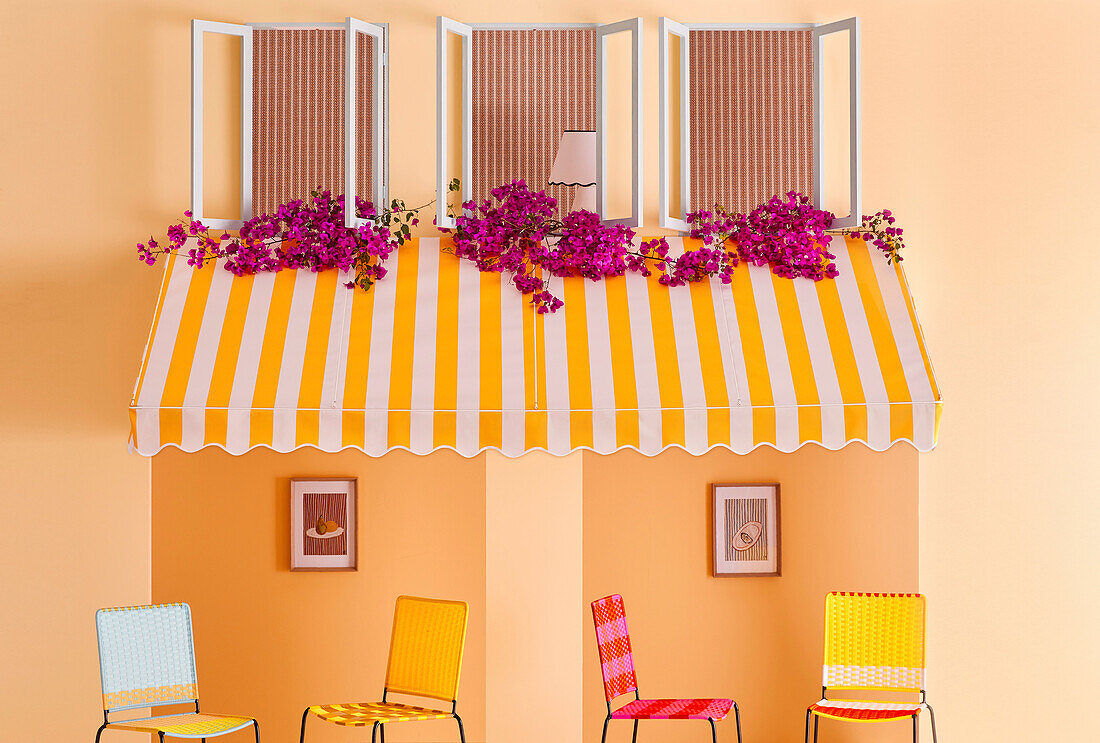 Yellow and white striped awning over colourful chairs