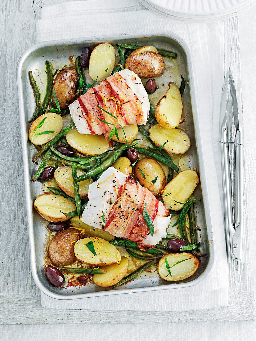 Fish wrapped in pancetta with lemon potatoes, green beans and olives