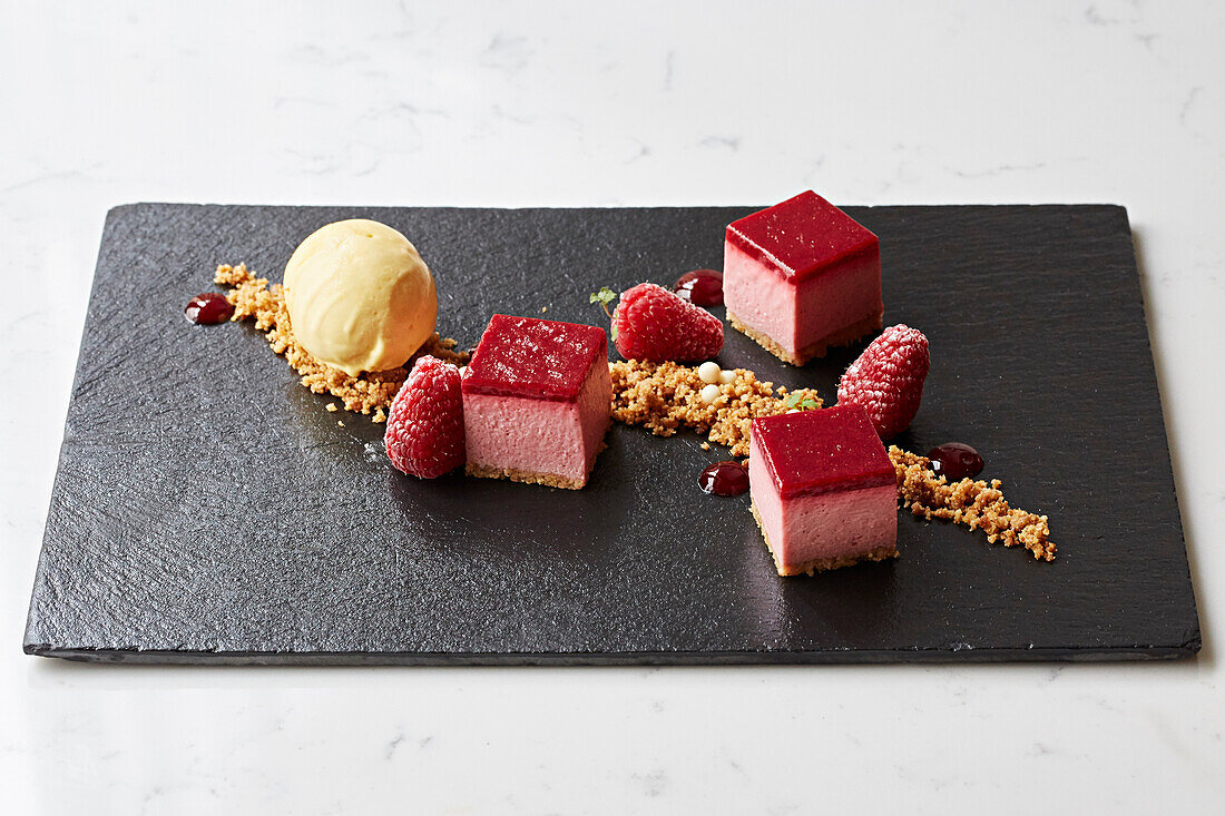 Raspberry dessert with ice cream on a slate