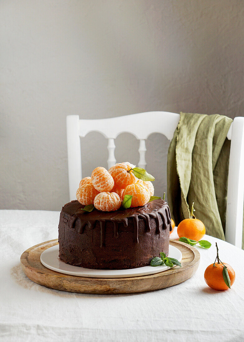tangerines chocolate cake, birthday concept, linen white tablecloth