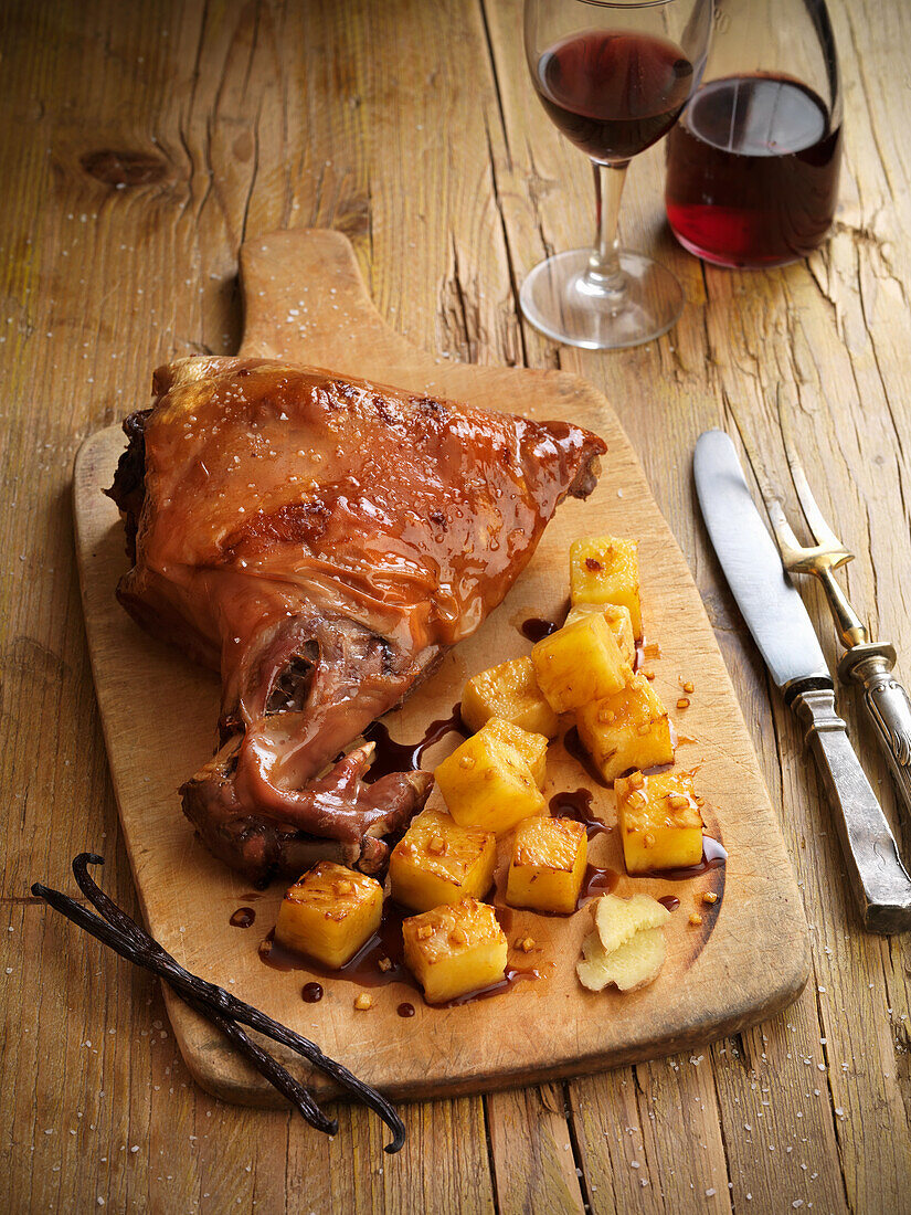 Roast suckling pig with roast potatoes and vanilla red wine sauce