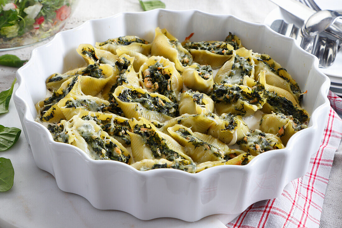 Baked pasta shells stuffed with spinach and salmon