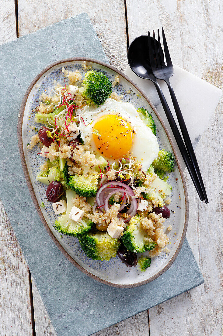 Salad with broccoli, quinoa, feta cheese, and egg