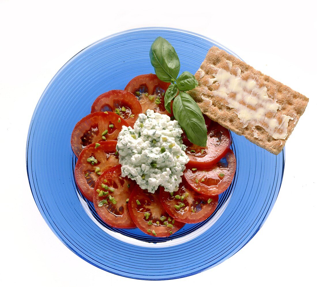 Tomato salad with cottage cheese, decoration: crispbread