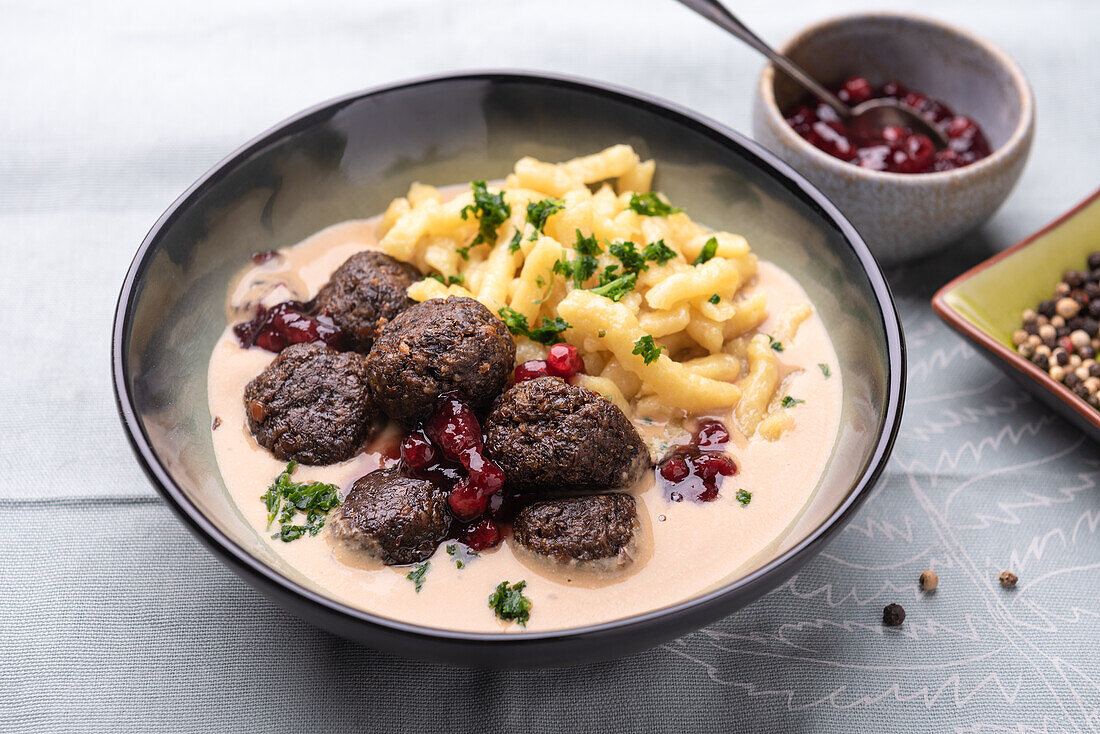 Vegan meatballs made from lentils with cranberries and spaetzle