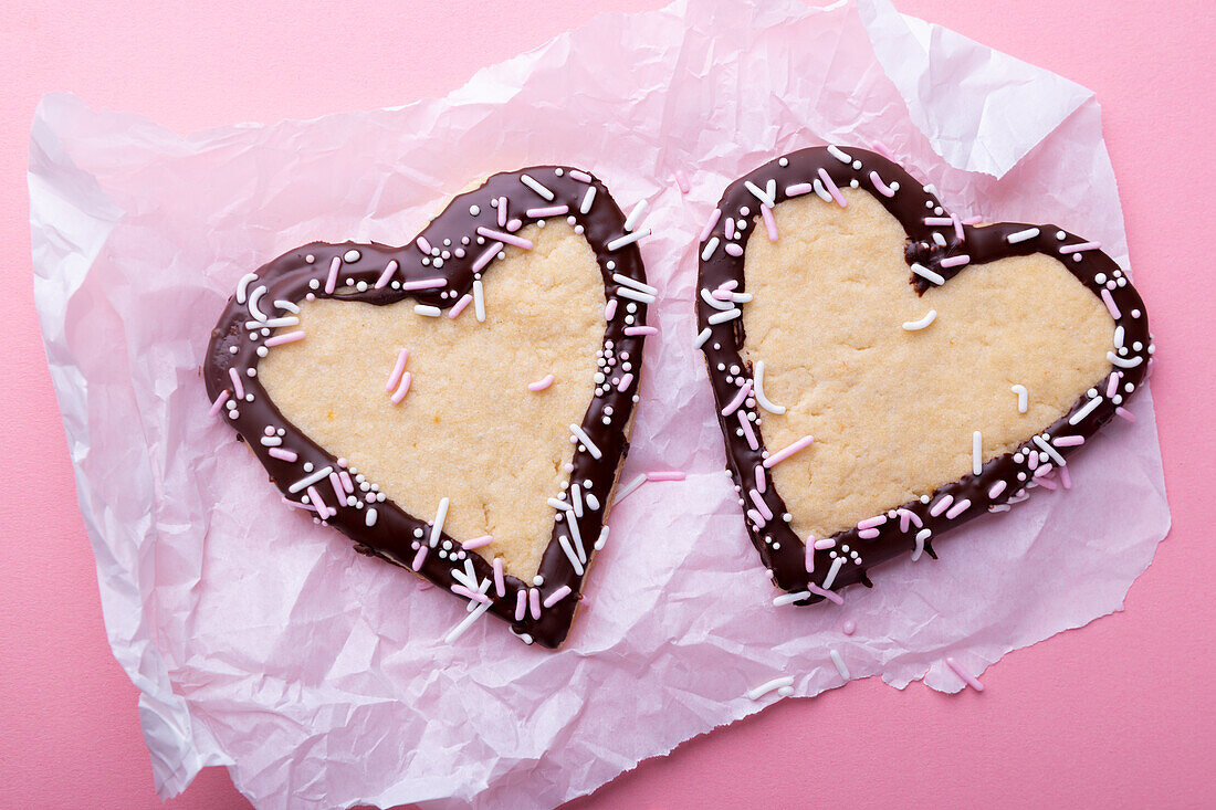 Vegan vanilla shortcrust hearts with plain icing and sprinkles