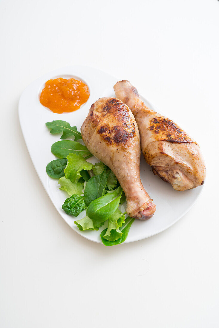 Turkey legs with a honey glaze, served with apricot sauce and salad