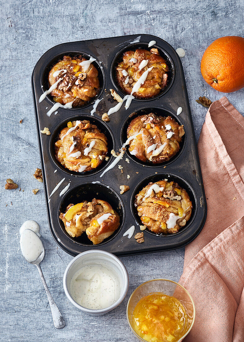 Kanelbullar with orange marmalade and walnuts baked in a muffin tray
