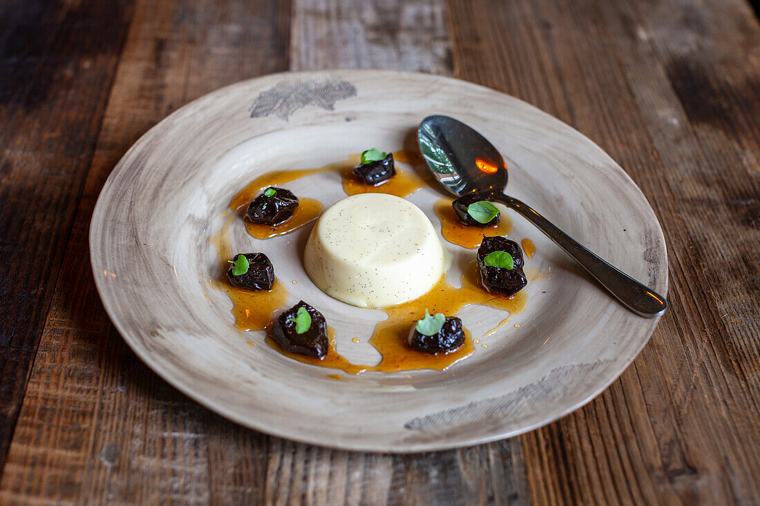 Panna cotta with dried plums and basil