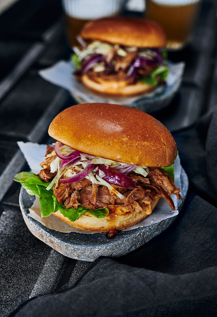 Pulled pork burgers on dark surface