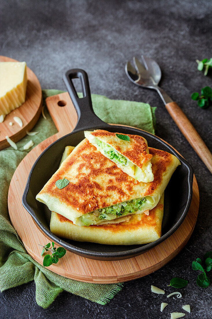 Envelopes of pancakes stuffed with cheese and broccoli
