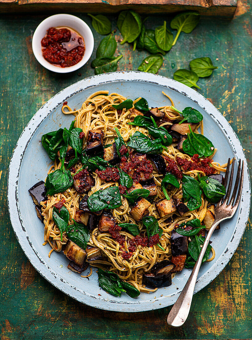 Edamame noodles with aubergine and tomato spinach sauce