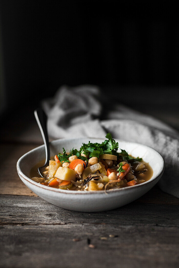A bowl of vegetable soup with chickpeas