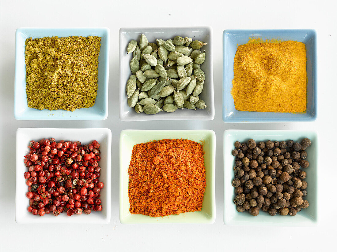 Six different spices in small bowls