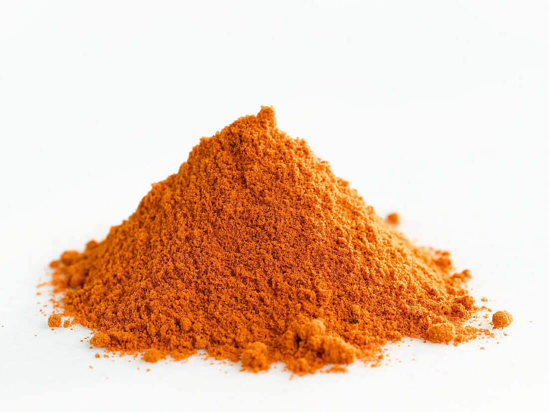 A heap of chilli powder on a white background