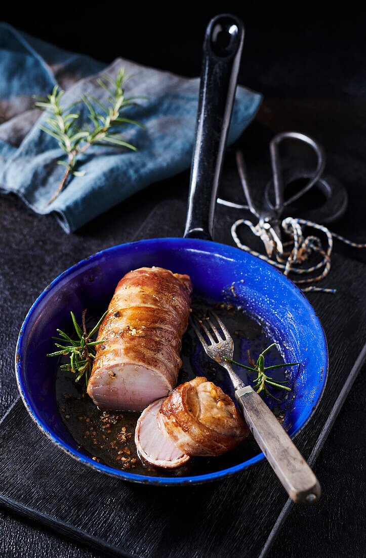 Bacon wrapped Pork fillet in a pan