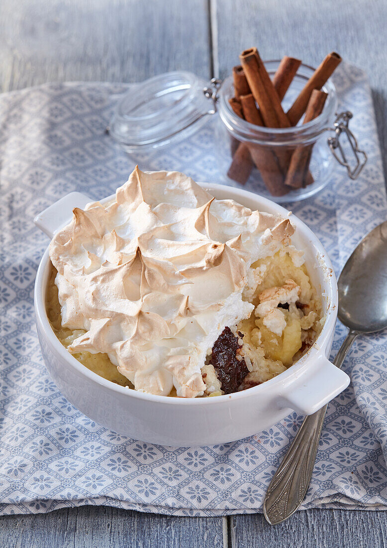 Rice pudding with port wine plums and meringue topping
