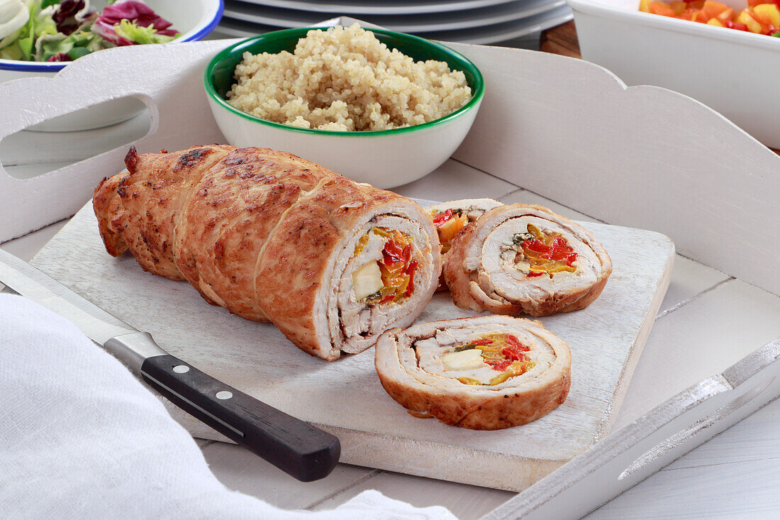 Turkey roulade stuffed with colorful peppers and feta cheese