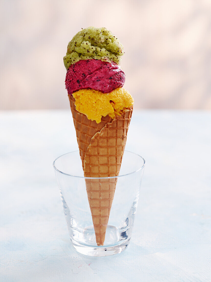 Summer ice cream cone with mango kulfi ice cream, berry ice cream and kiwi sorbet