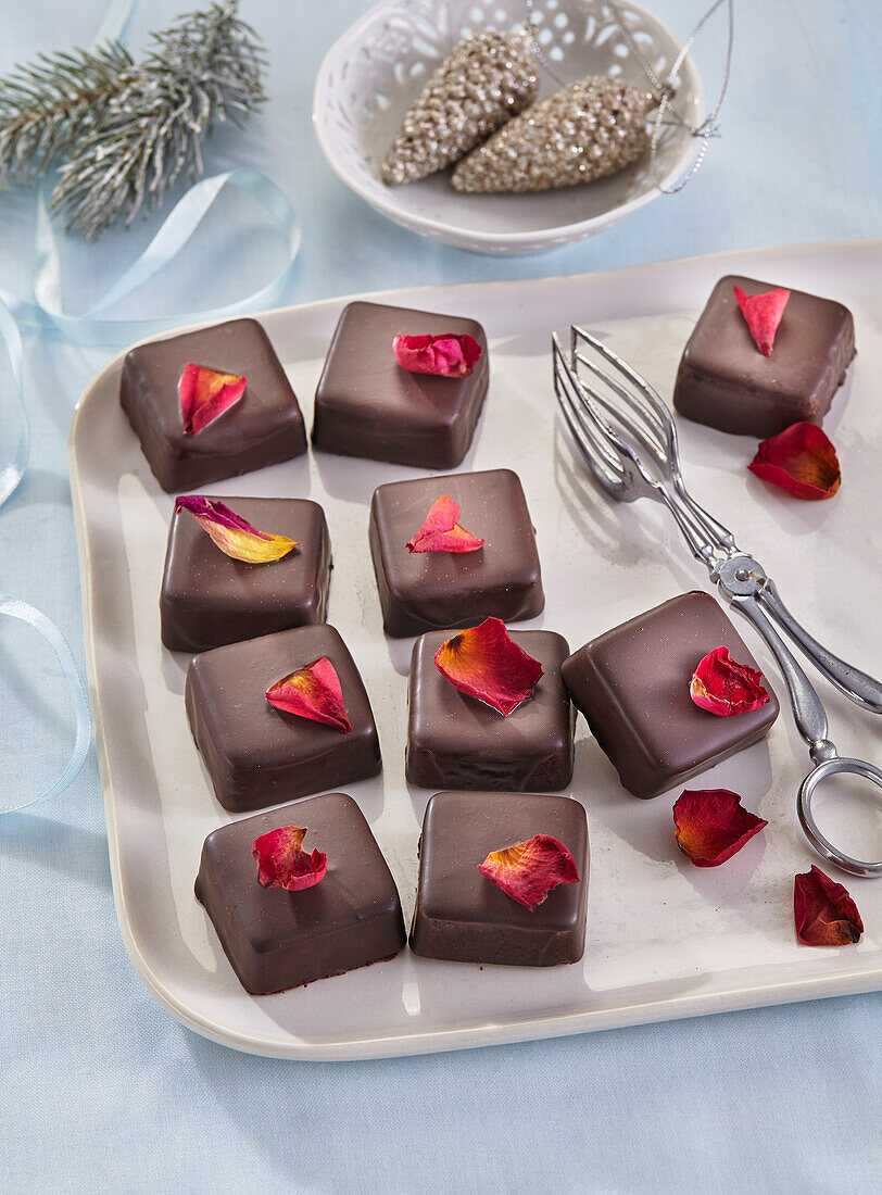 Gluten-free cubes of chocolate-coated jelly with rose petals (Christmas)