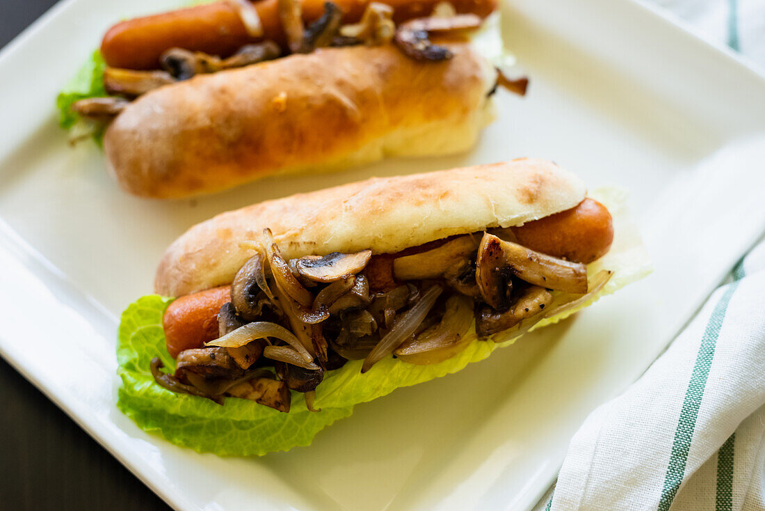 Chicken hot dog with fried mushrooms and romaine lettuce