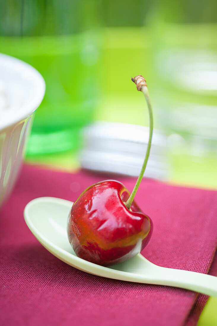 A cherry on a spoon