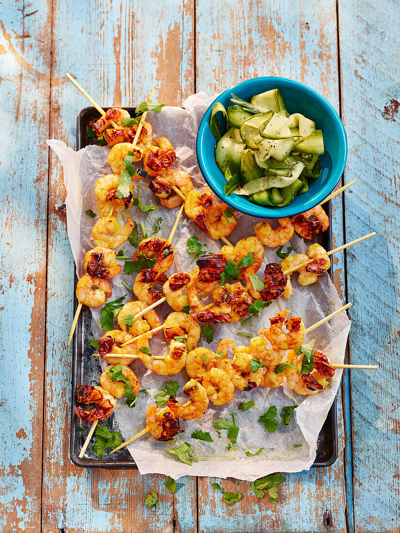 Skewers with masala prawns and pickled cucumber