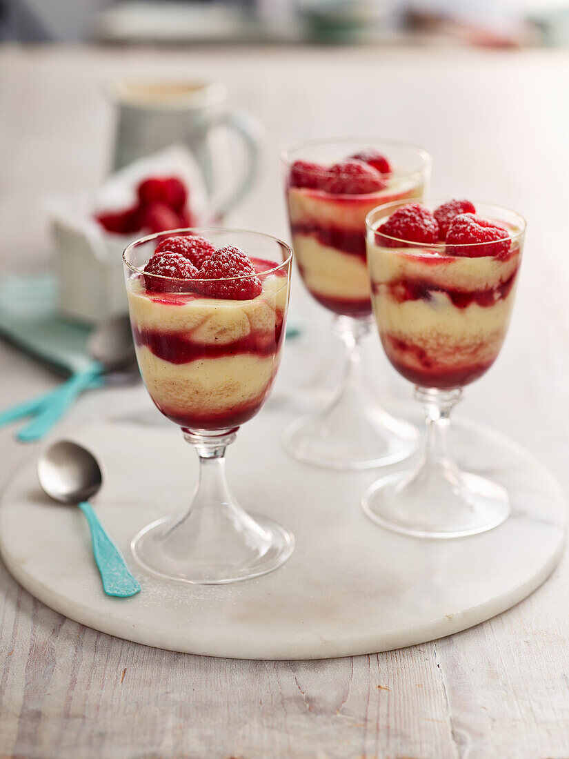 Layered dessert with vanilla pudding and raspberries