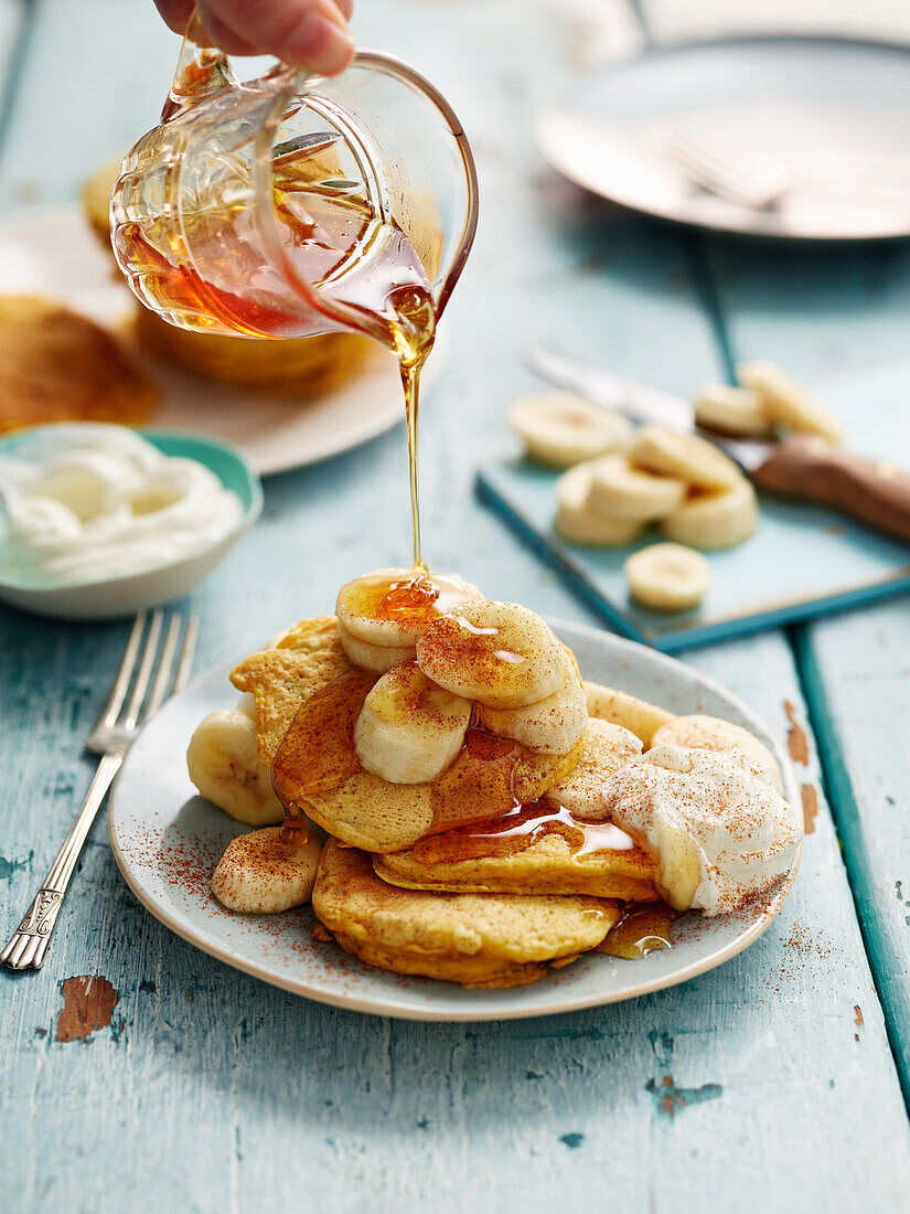 Oat pancakes with bananas, yogurt, and maple syrup