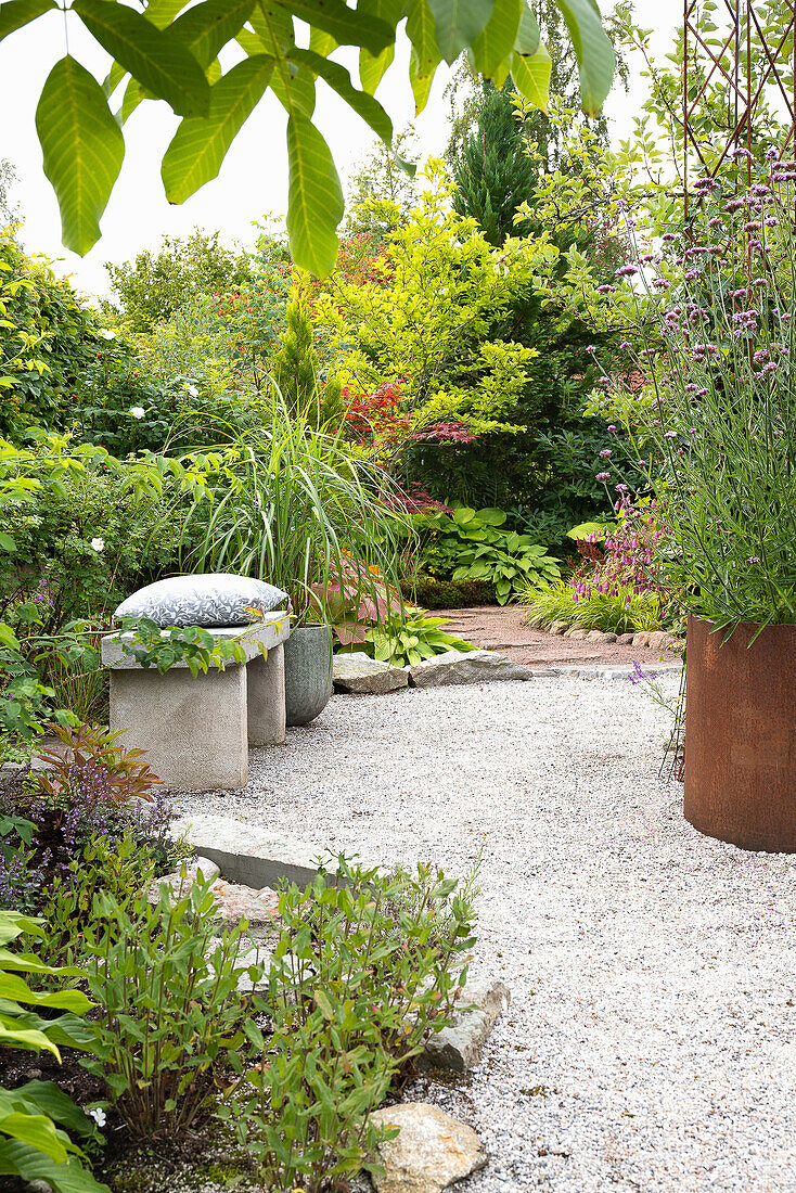 Winding garden path with gravel and surrounding planting