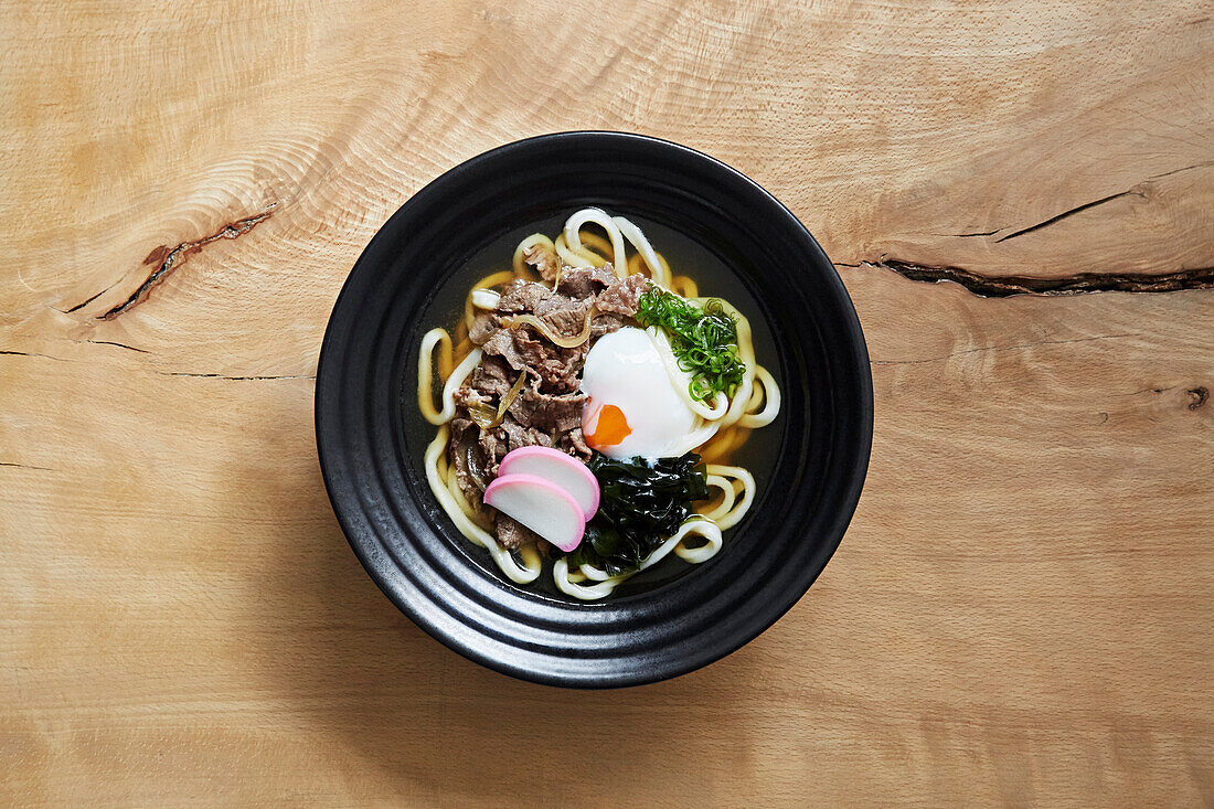 Ramen with udon noodles, shredded beef, seaweed and an egg