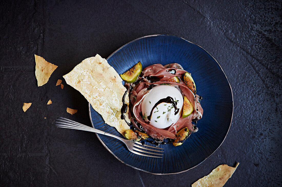 Burratta served with fig, balsamic vinegar and parma ham
