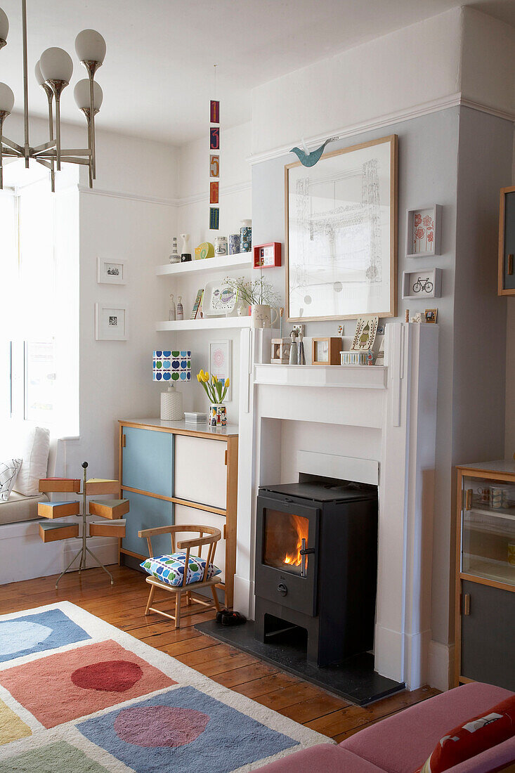 Wood burning stove in living room with patterned rug