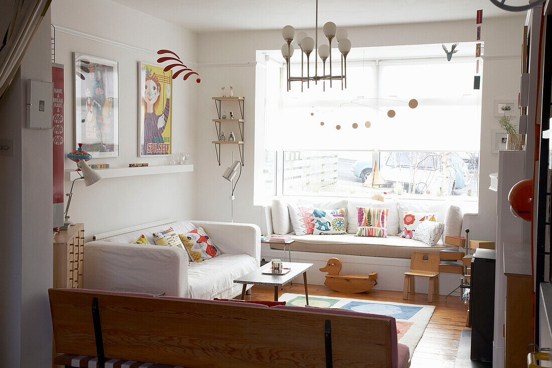Living room with colourful retro accessories and white decor