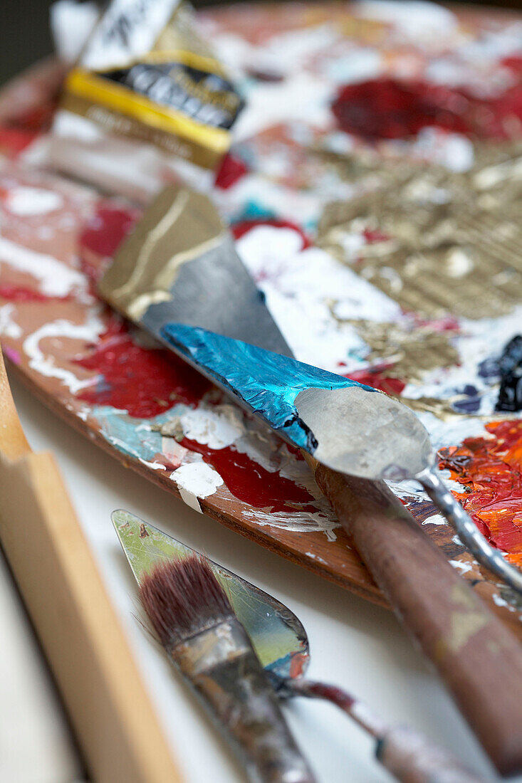 Paint palettes and brushes in workshop