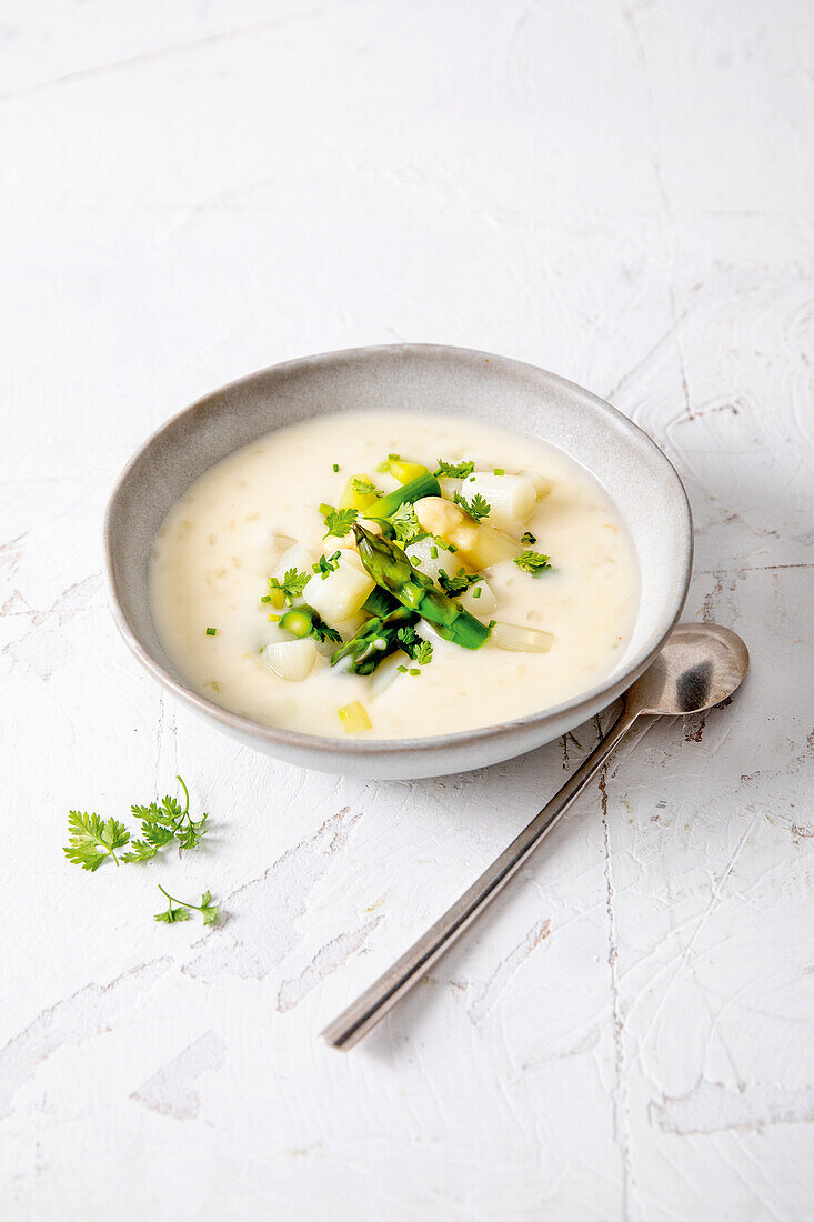 Asparagus soup green-white with cream and chervil