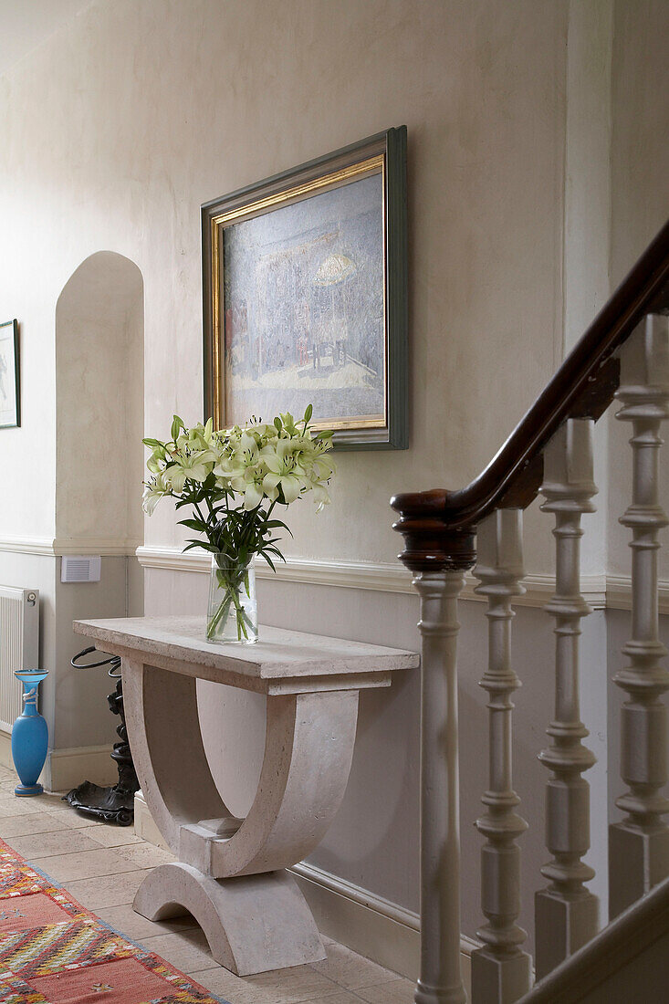 Cut flowers on marble console in Arundel entrance hallway, West Sussex