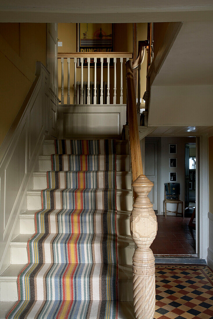 Striped carpet contrasts with chequered floor in Rye entrance hallway Sussex