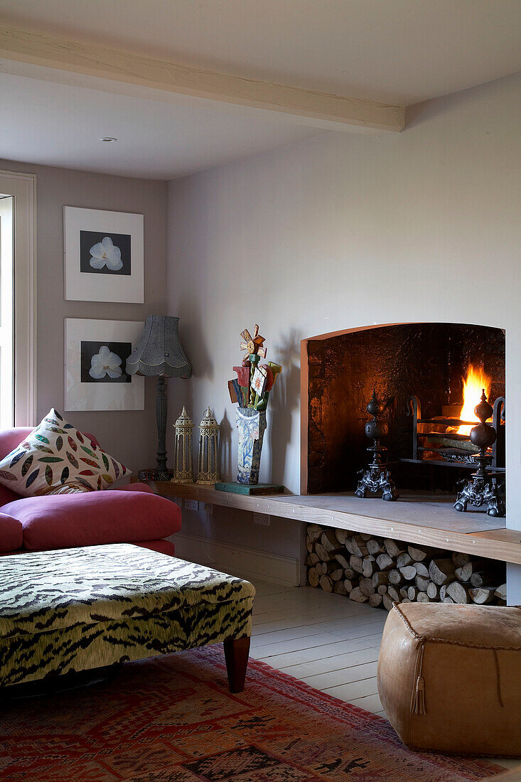 Artwork and sofa with patterned ottoman at hearth in Rye, Sussex