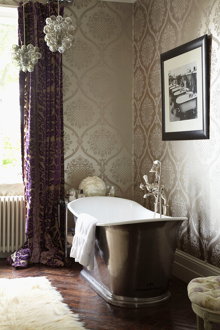 Freestanding bath in bathroom of London fashion designer