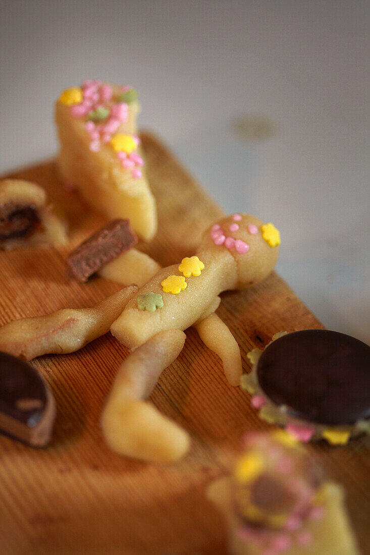 Marzipan cakes on wooden chopping board