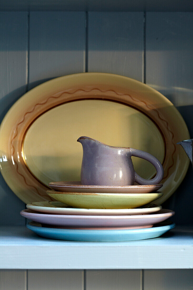 Jug and plates on kitchen dresser in Brighton home, Sussex, UK