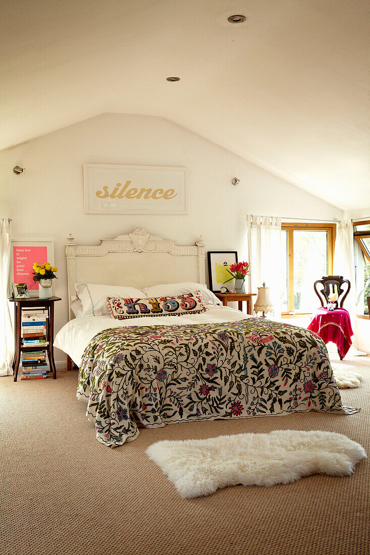 Embroidered bed cover in bedroom of houseboat in Richmond upon Thames, England, UK