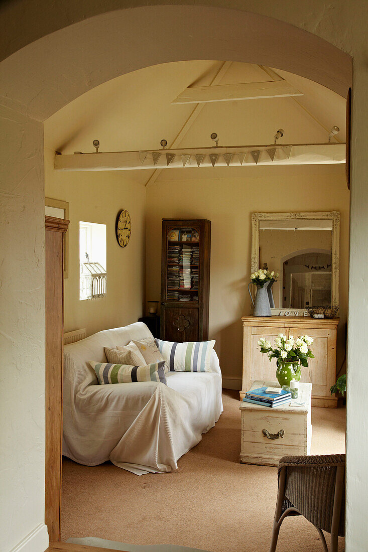 View through arched doorway to living room of West Sussex home, England, UK