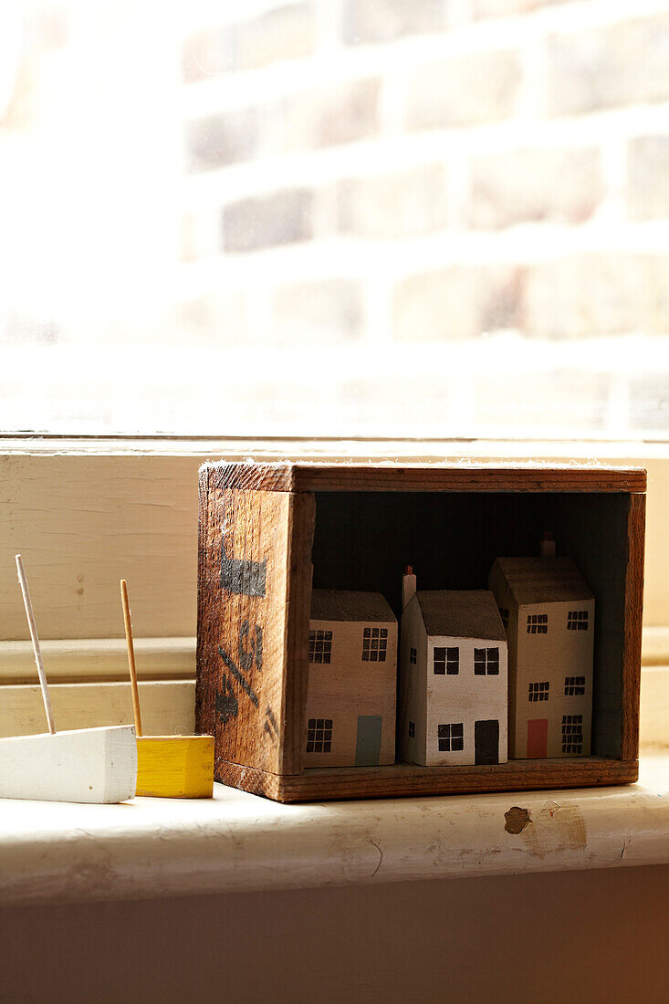 Hand painted dolls houses with toy boats on windowsill in Brighton home, UK