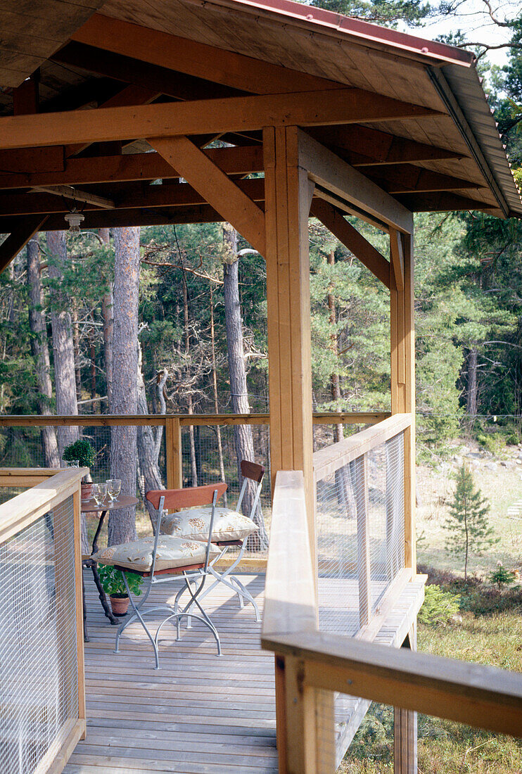 Table and chairs on a veranda with decking