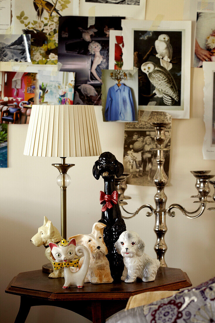 Animal figurines and silver candlestick on wooden side table in Lincolnshire home, England, UK