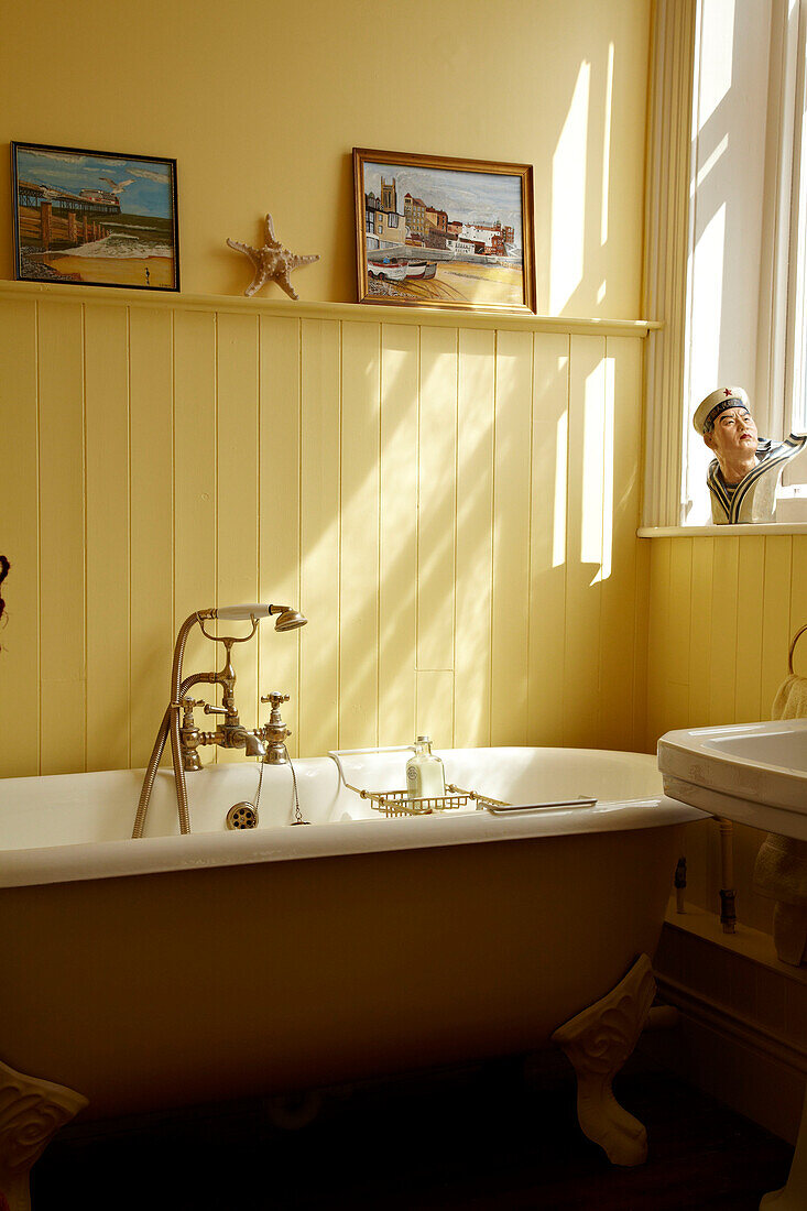 Freestanding roll top bath in Cromer beach house, Norfolk, England, UK